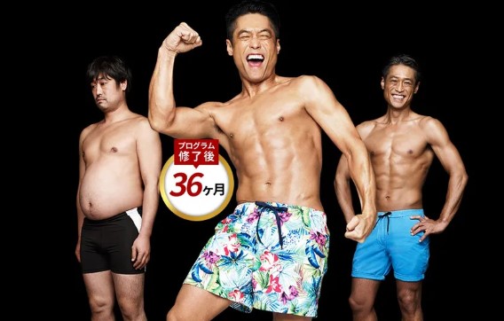 Three shirtless men in swim trunks posing against a black background; center man flexes his bicep.